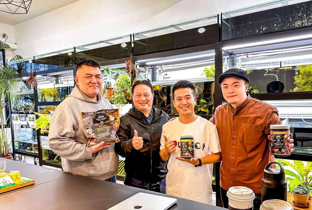 四人在辦公室櫃檯前手持鮮蝦食譜產品合影